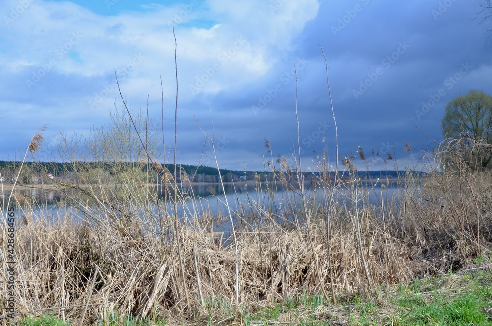 A beautiful endless lake in the late afternoon. The lake displays the sky like a mirror. Mirror-like clear water. Magic view of the lake in the evening. Fabulous nature.	