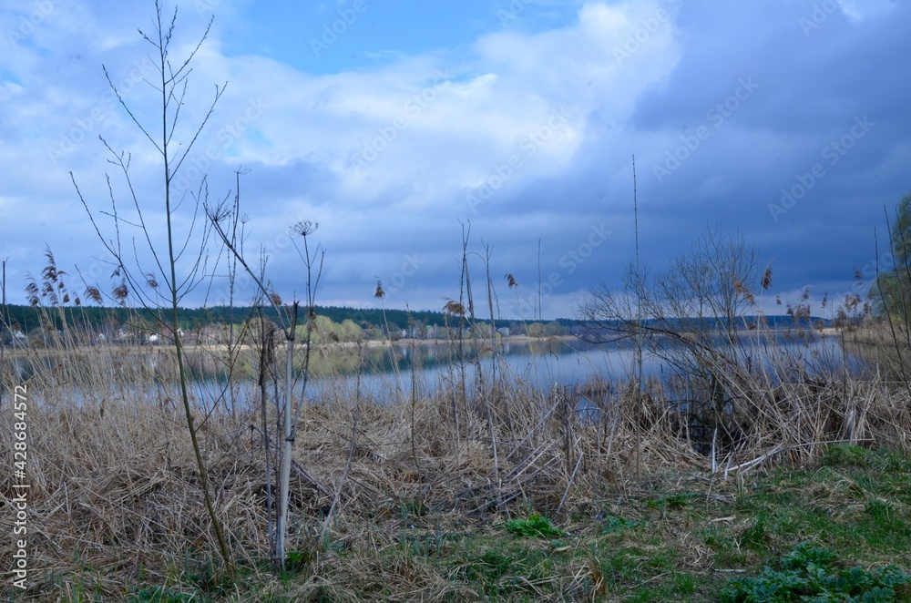 A beautiful endless lake in the late afternoon. The lake displays the sky like a mirror. Mirror-like clear water. Magic view of the lake in the evening. Fabulous nature. A beautiful endless lake in the late afternoon. The lake displays the sky like a mirror. Mirror-like clear water. Magic view of the lake in the evening. Fabulous nature.