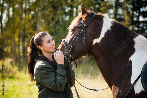 Tender communication between a rider and her horse before a riding lesson © Anna Kosolapova