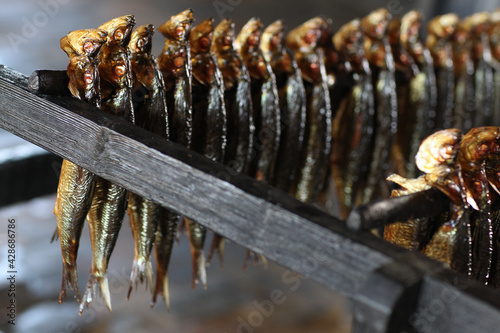 Smoked herrings on pole photo