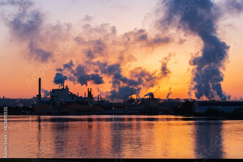 sunset over a smoke stack