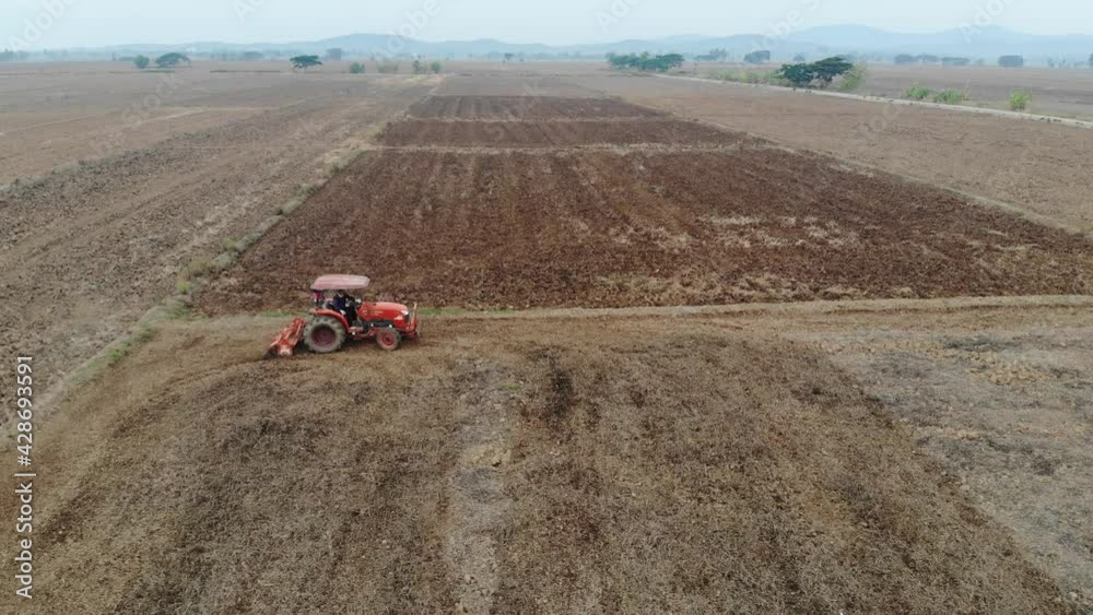 Rice plantation prepare soil by tractor aerial view agricultural industry Rice plantation prepare soil by tractor aerial view agricultural industry