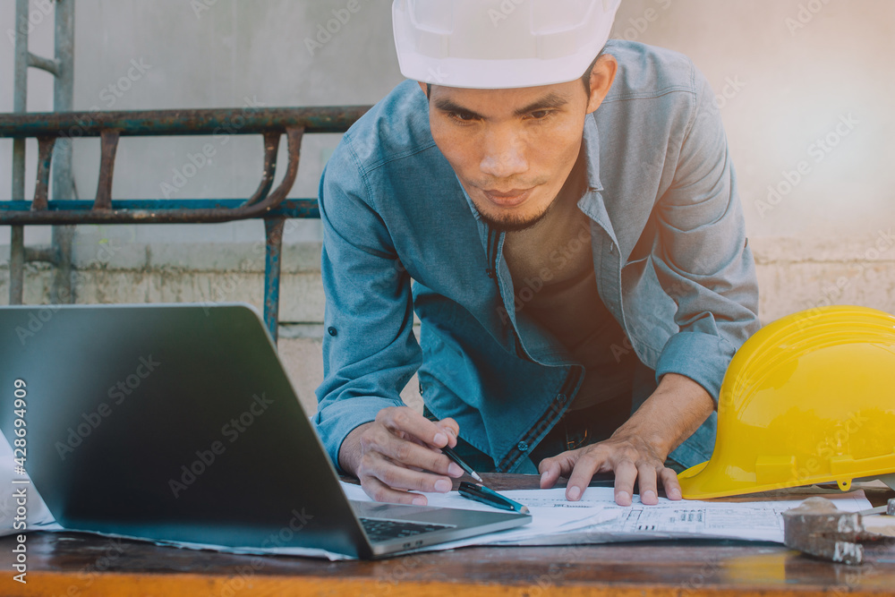 Engineer checking design building construction by computer technology Engineer checking design building construction by computer technology