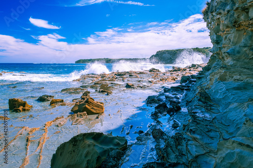 Rugged ocean coastline with powerful waves splashing in Australia photo