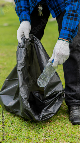 Collect plastic bottles on the grass in the park clean up the woods help environmental charity waste collection ideas