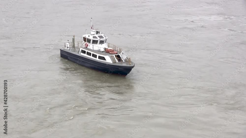Blue and white vessel maneuvers slowly in the Panama Canal. Blue and white vessel maneuvers slowly in the Panama Canal.