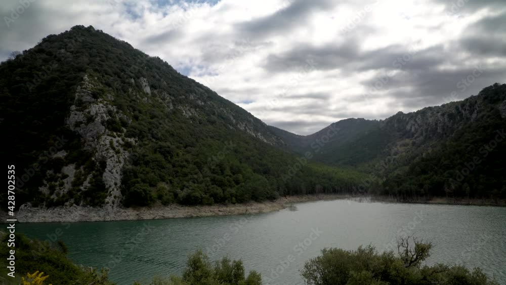 Majestic mountain on vast river on cloudy day, static view