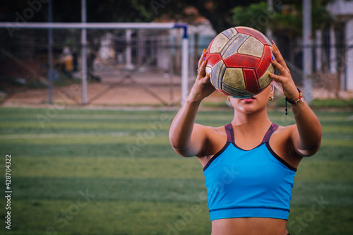 Woman with soccer ball under her armband