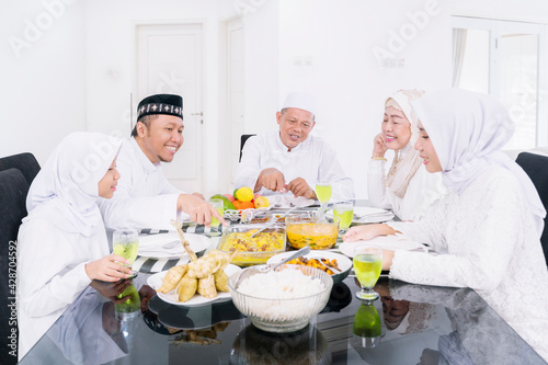 Happy Muslim family having meals during Eid Mubarak