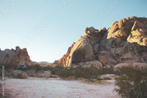 A view of a campground area set up hidden among the rocky terrain of Joshua Tree National Park.