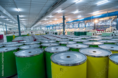 Yarn manufacturing company machineries including packaging, raw materials in drum, aligned in a raw