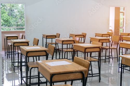 School empty classroom with test sheet or exams paper on desks chair wood at high school thailand  Empty classroom no childrens when COVID-19 disease outbreak and closed quarantine