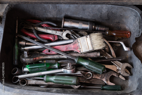 Old Box with tools equipment on floor against for Fix mechanic motor in workshop inustrial photo