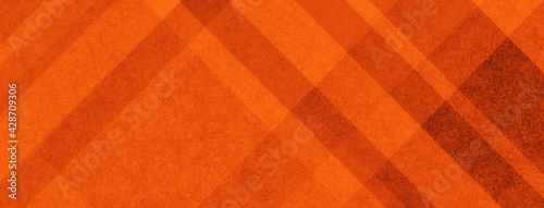 Orange background pattern with abstract diagonal stripes layered in geometric design for thanksgiving or autumn or fall backgrounds, striped plaid material illustration photo