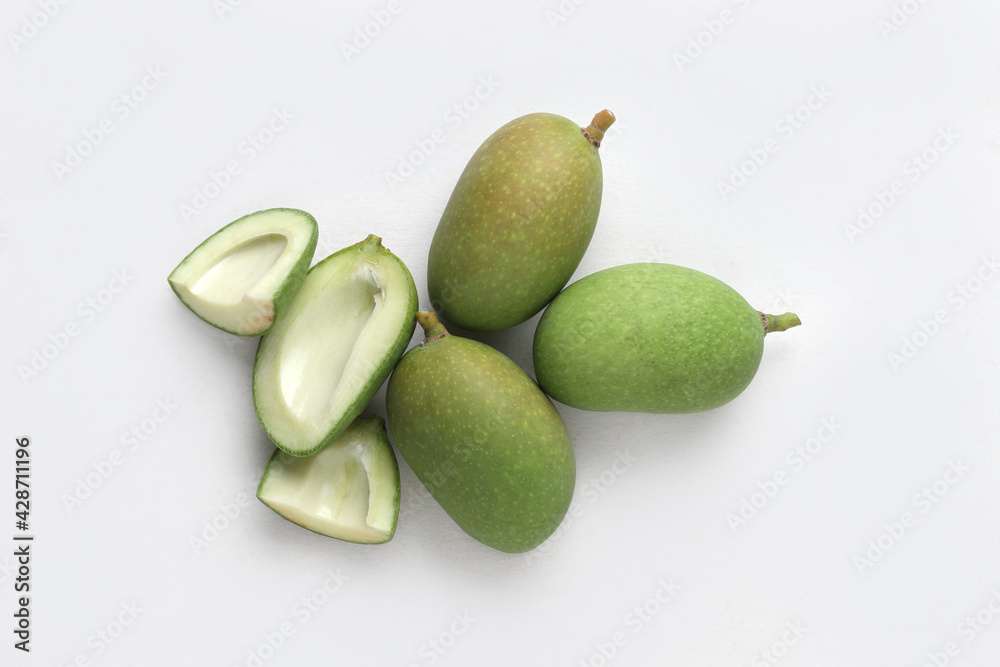 Tender mango on a white base for Indian style mango pickle. Tender mango on a white base for Indian style mango pickle.