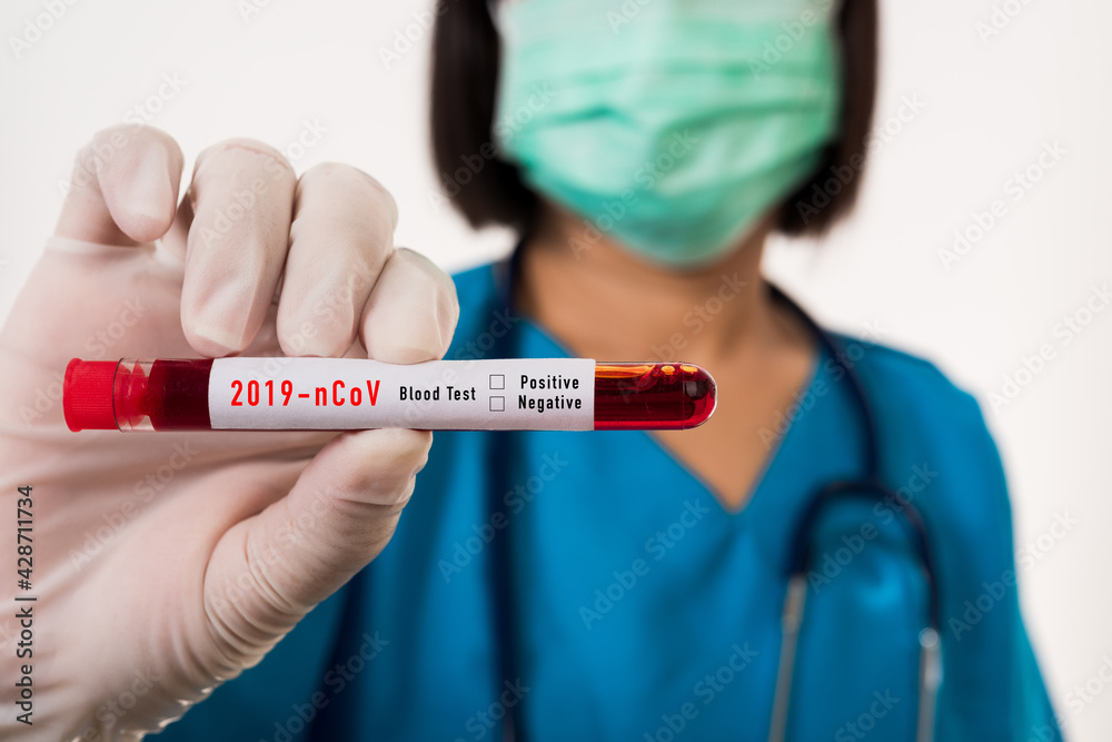 Nurse in blue uniform wear a mask holding test tube sample Coronavirus test blood in the laboratory for analyzing isolated on white background, medicine COVID-19 pandemic outbreak concept
