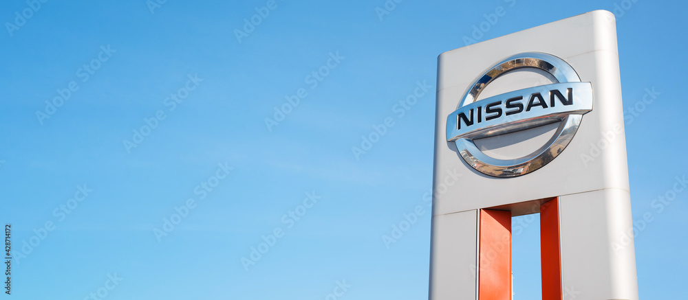 Nissan car manufacturer Japanese company logo, clear blue sky background outside. Banner, copy space, blank space for your text. foto de Stock | Adobe Stock