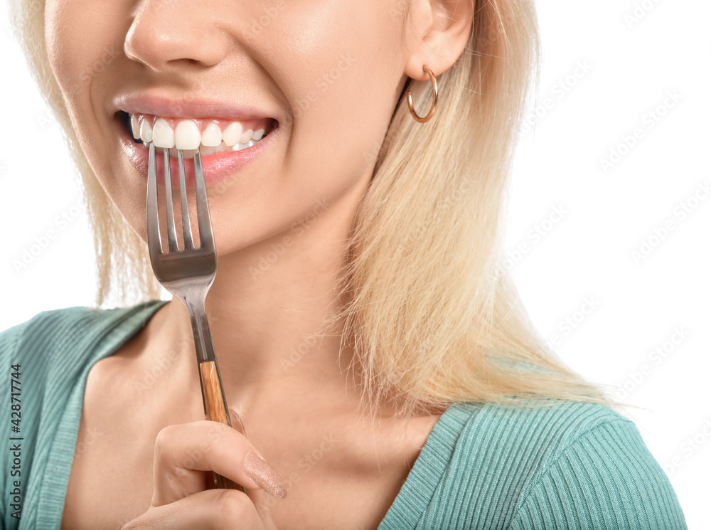Beautiful young woman with fork on white background, closeup