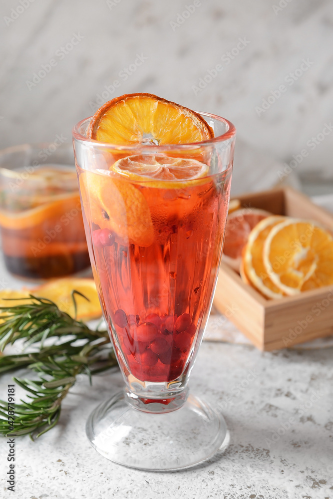 Glass of cocktail with berries and dried citrus fruits on grunge background Glass of cocktail with berries and dried citrus fruits on grunge background