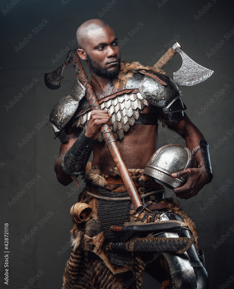 Brave african soldier from the past looking at camera holding an axe Brave african soldier from the past looking at camera holding an axe