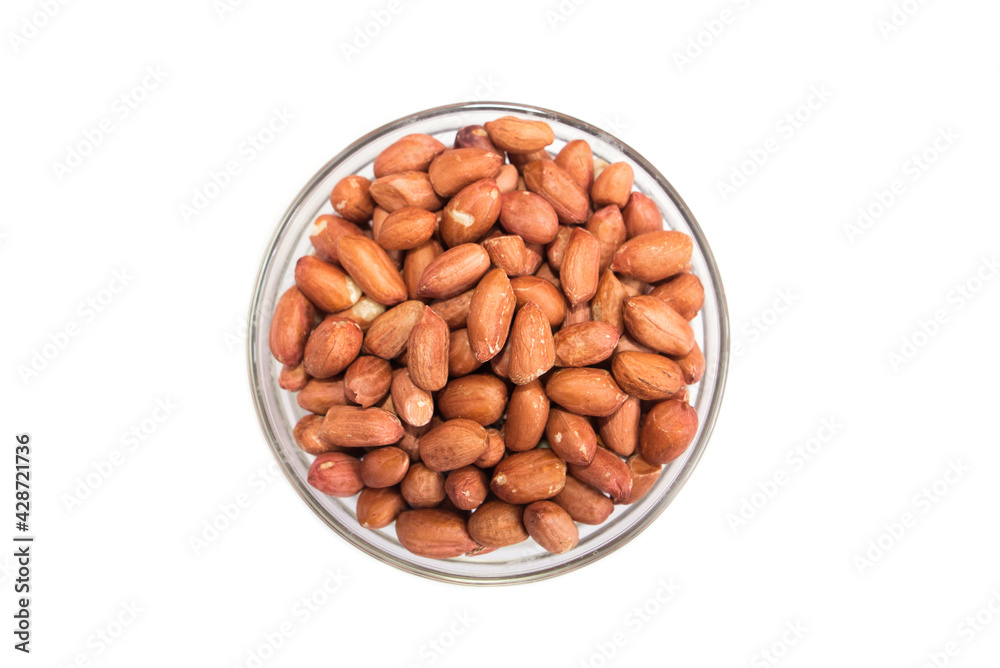 peanuts in a glass bowl on a white background. peanuts in a glass bowl on a white background.