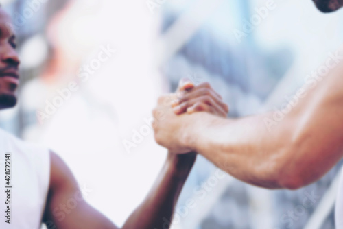 blurred Successful sport man handshaking after match. Handshake partnership deal meeting concept. Happy people shaking hands. Black and white Teamwork Concept.