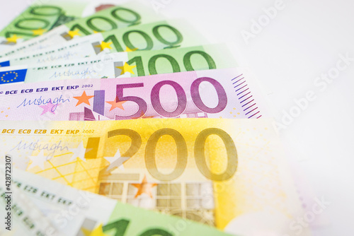 Close-up of Euro banknotes on a white background. The money is beautifully fanned out.