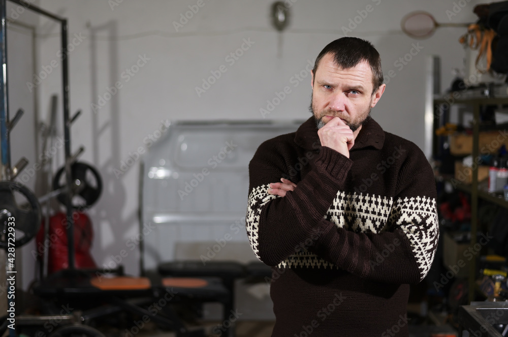 Photo of adult caucasian man in workshop thinking Photo of adult caucasian man in workshop thinking