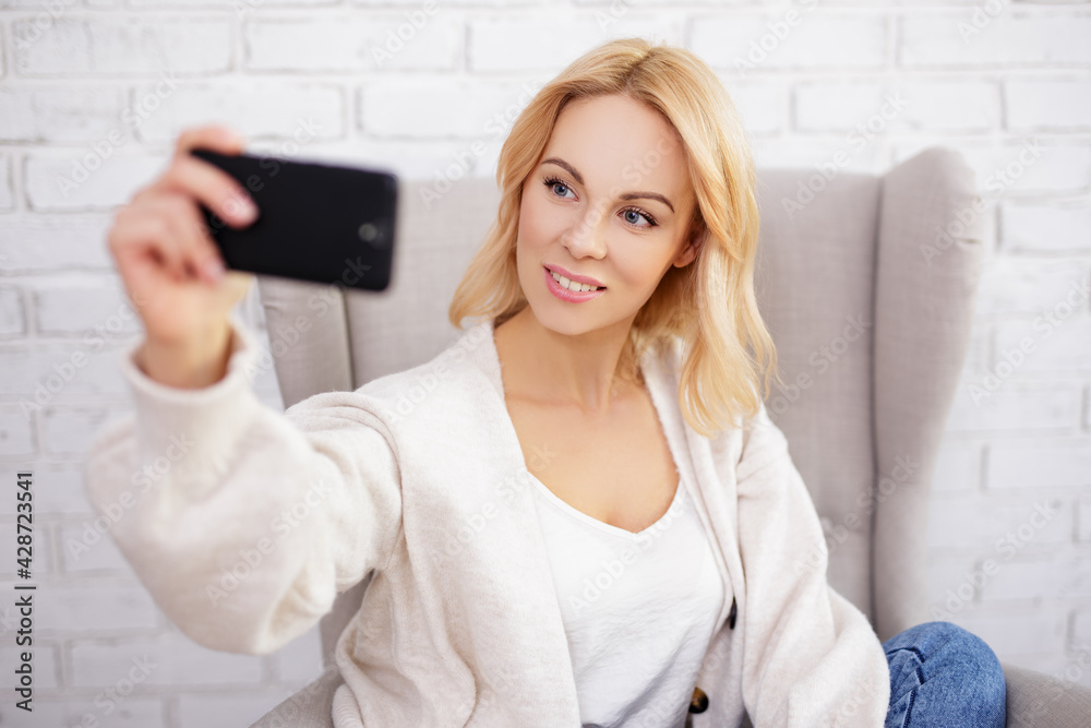 portrait of young beautiful woman taking selfie by smart phone portrait of young beautiful woman taking selfie by smart phone