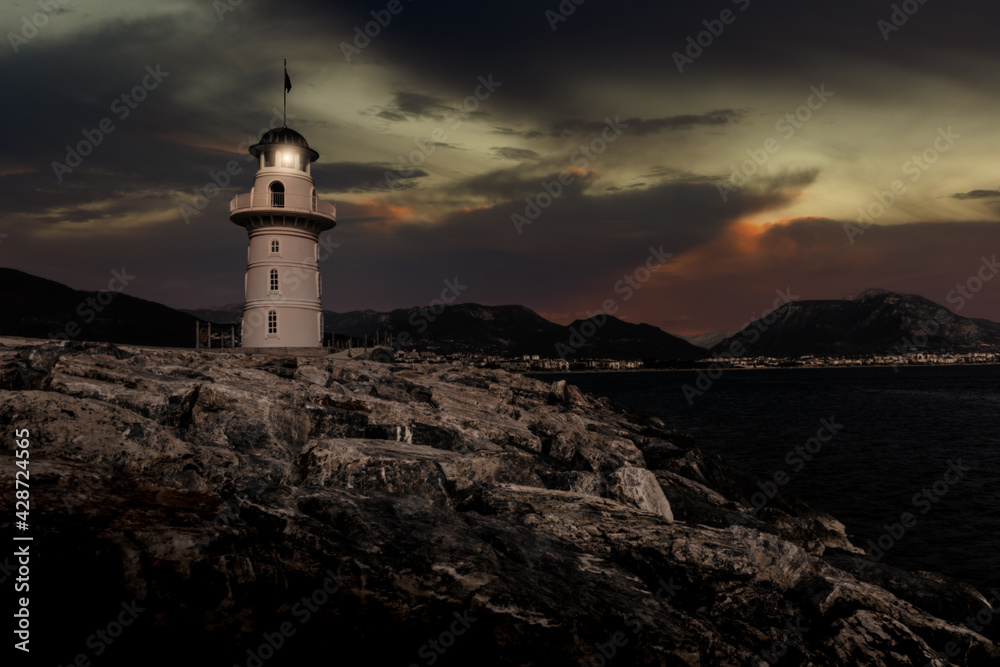 Lighthouse on a mediterranean coast at night.