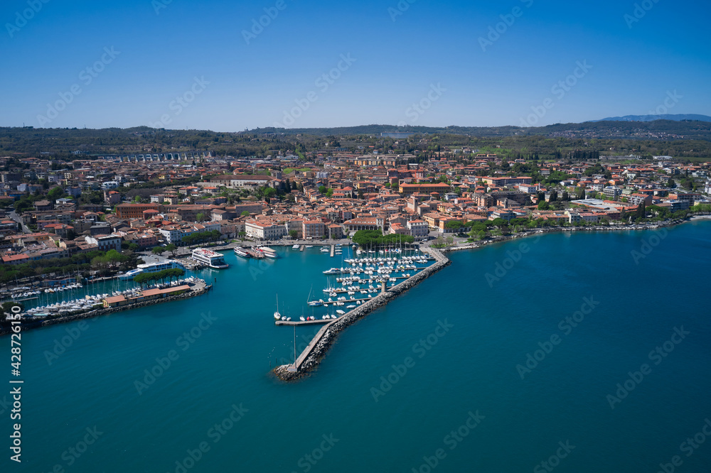 Aerial panorama of Italian cities. Aerial view of the coastline of the city of Desenzano del Garda on Lake Garda, Italy. Desenzano del garda port.