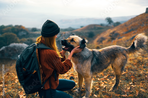 woman next to a dog outdoors vacation friendship © SHOTPRIME STUDIO