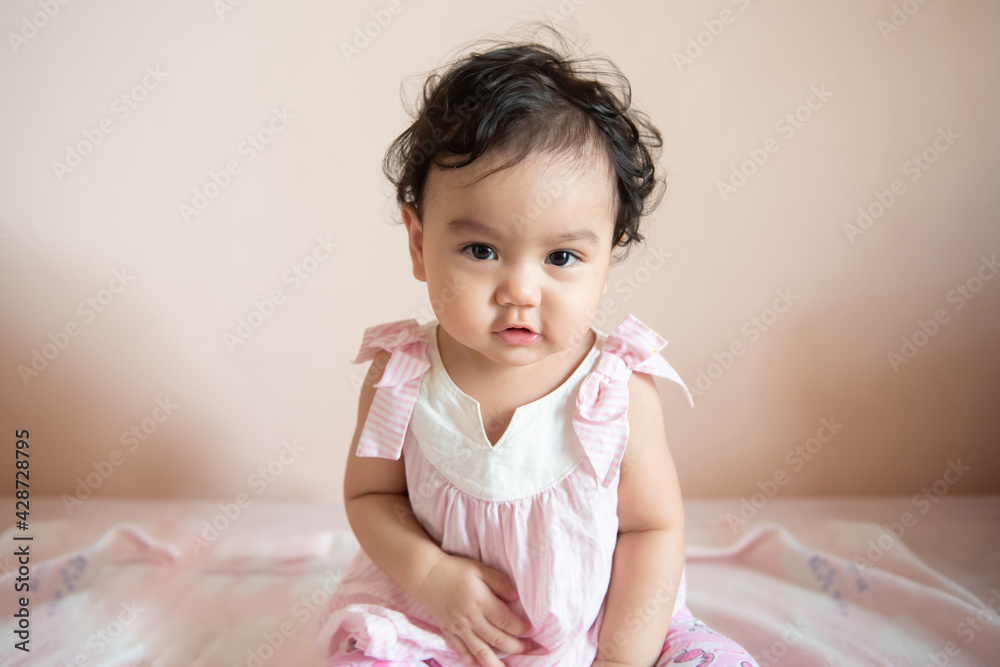 Portrait of a cute happy little Asian baby girl she look at camera, baby expression concept Portrait of a cute happy little Asian baby girl she look at camera, baby expression concept
