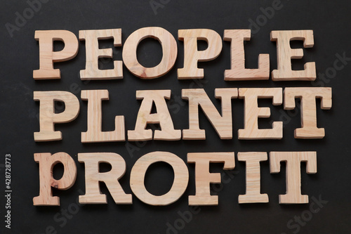 People Planet Profit, text words typography written with wooden letter on black background, life and business motivational inspirational