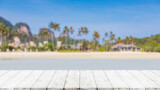 Empty wood table top and blurred summer beach in tropical resort banner background - can used for display or montage your products.