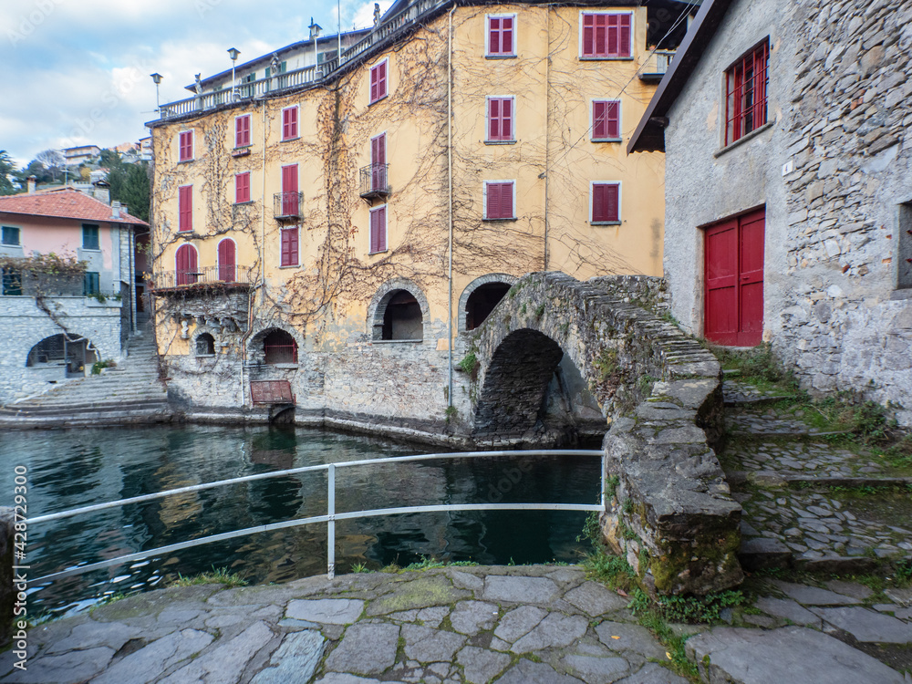Famous stone arch bridge over Lake Como in Nesso village, Lombardy, Italy Famous stone arch bridge over Lake Como in Nesso village, Lombardy, Italy