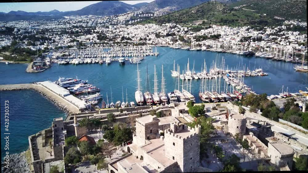 Amazing panoramic view from drone of beautiful full of yachts Bodrum harbour and ancient Kalesi castle in Mugla province in Turkey
