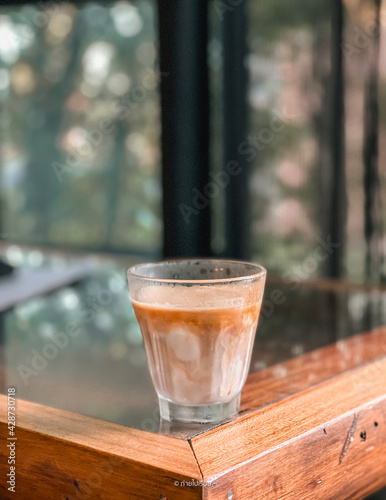 a glass of coffee with mil. Cafe concept