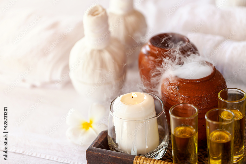 spa theme with candles on wooden background. Massage therapy for one person with candle light. Beauty spa treatment and relax concept. spa theme with candles on wooden background. Massage therapy for one person with candle light. Beauty spa treatment and relax concept.
