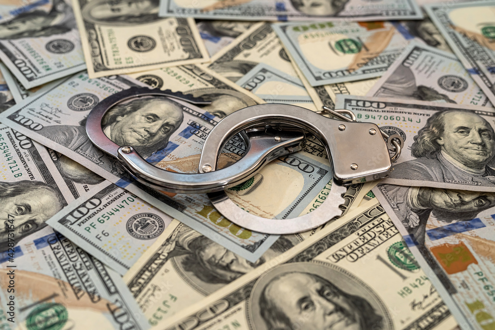 handcuffs on american hundred dollar bills handcuffs on american hundred dollar bills