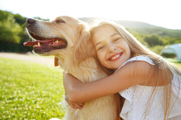 Teenager girl with a dog in nature. High quality photo.
