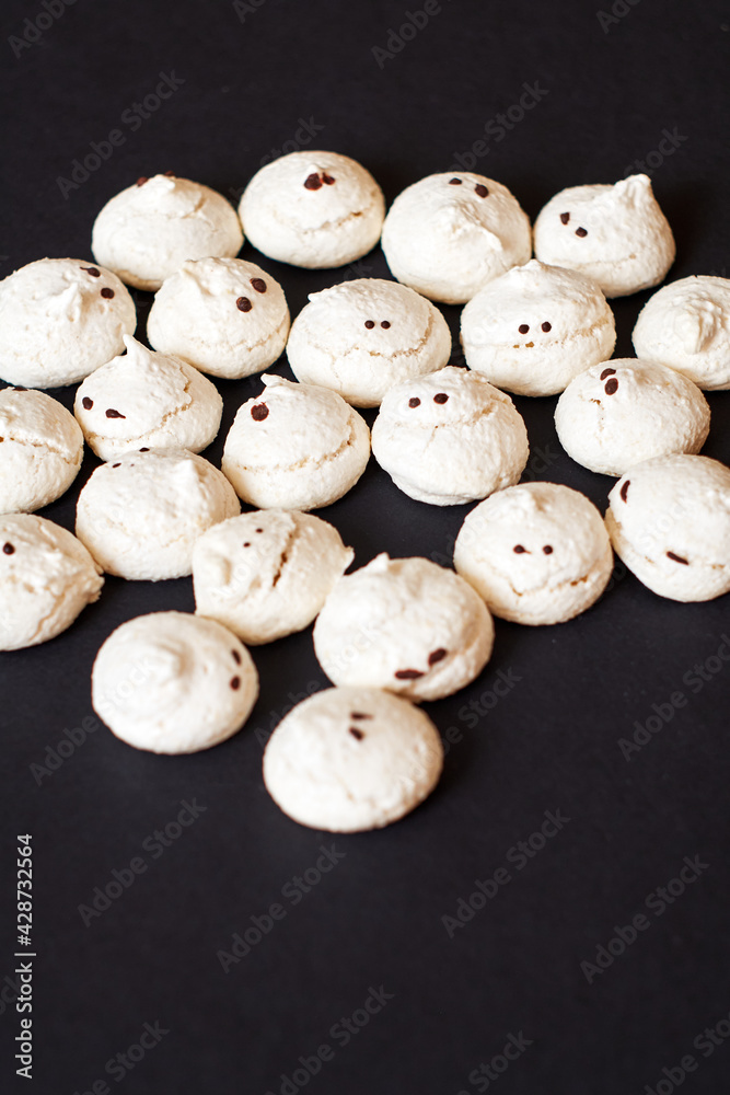 Funny and delicious meringue ghoast as halloween party decor. 
