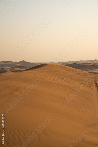 Landscape of desert dunes at sunset