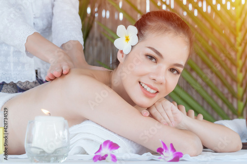 Masseur doing massage on woman body in the spa salon, Asian woman on massage bed relax and lifestyle, massage hands treatment. Beauty treatment concept.