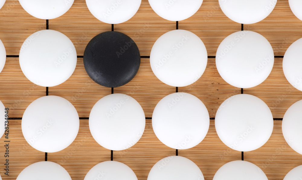 Black chess pieces surrounded by white pieces