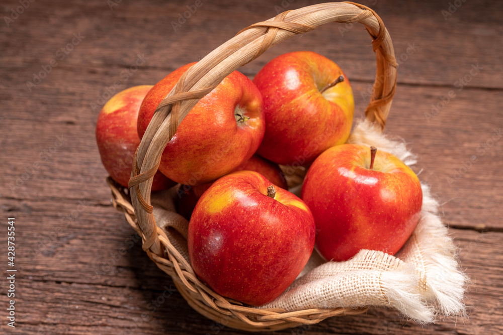 Envy Apple In a basket on a wooden floor. Envy Apple In a basket on a wooden floor.