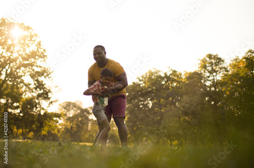 Day with dad. African American father and son having fun in nature.