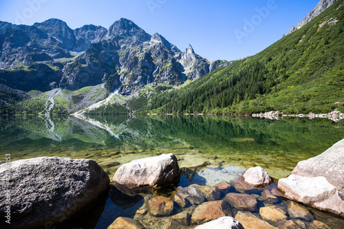 A landscape of a crystal clear lake in the mountains