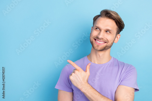 Photo portrait of guy showing finger blank space dreamy isolated on pastel blue color background