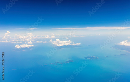 Nice cloud sky and island view through airplane window
